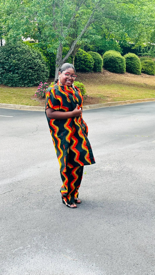Woman wearing a three-piece Ankara ensemble featuring a fitted top, wide-leg pants, and a flowing kimono-style jacket, standing outdoors.