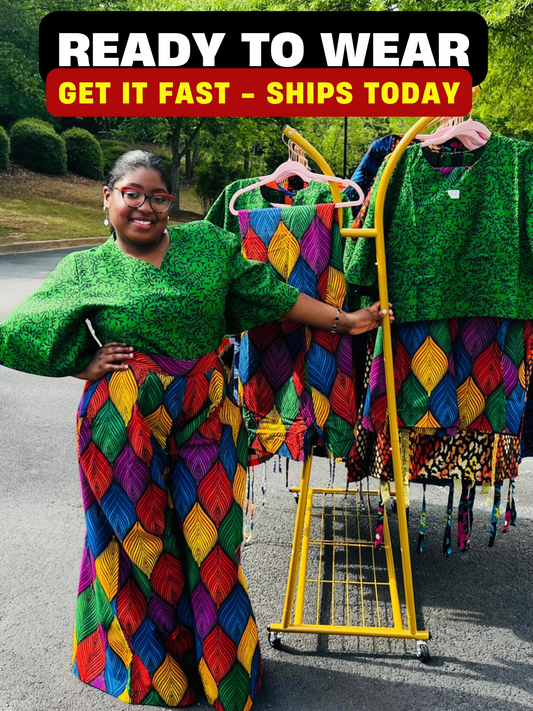 Woman wearing a vibrant two-piece Ankara outfit featuring a flare-sleeve top and matching baggy pants, standing outdoors.